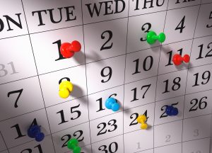 Close up , colorful pushpins on calendar